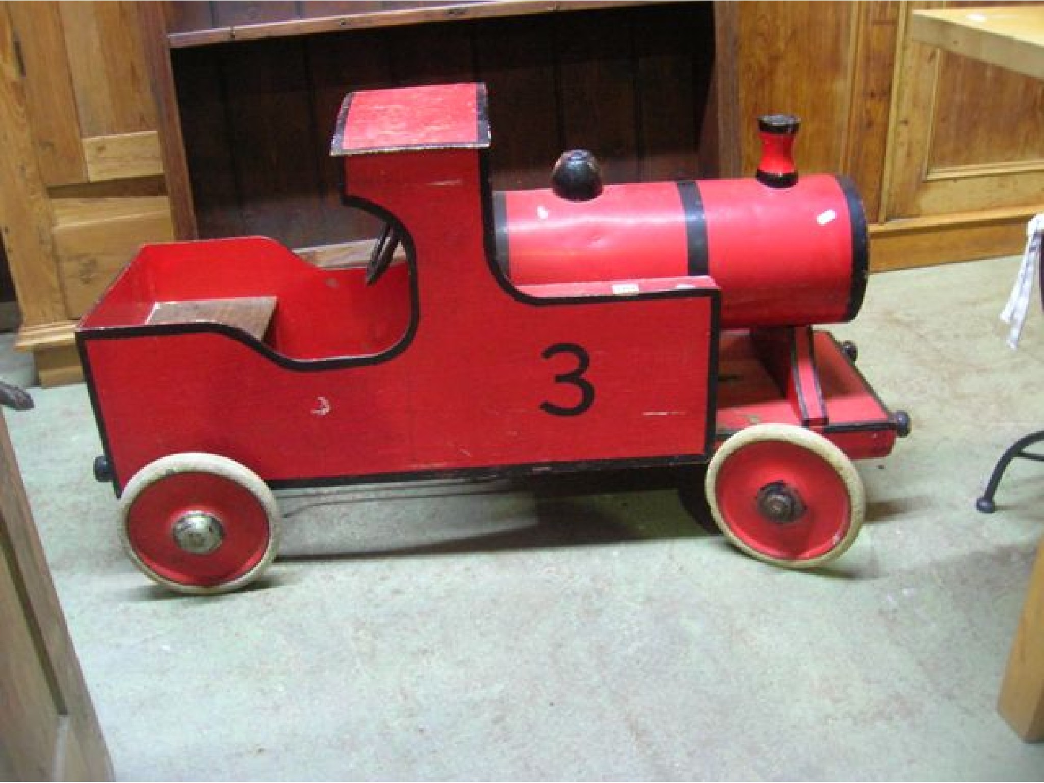 Appraisal: A vintage childs wooden pedal steam engine with painted finish