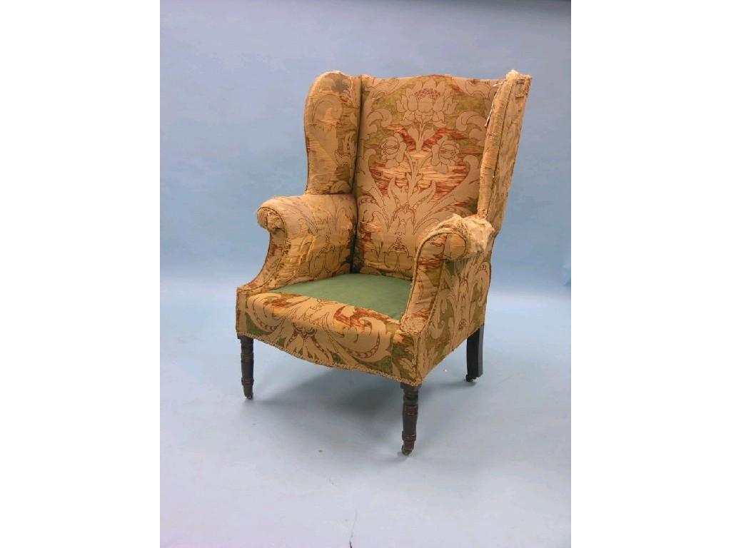 Appraisal: A George III wing armchair on front turned mahogany legs