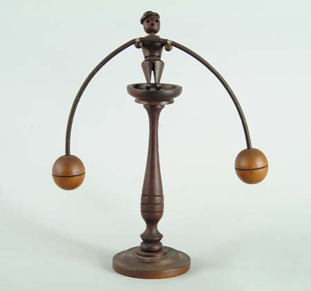 Appraisal: BALANCING MAN WOOD AND METAL TOY Carved wood man holds