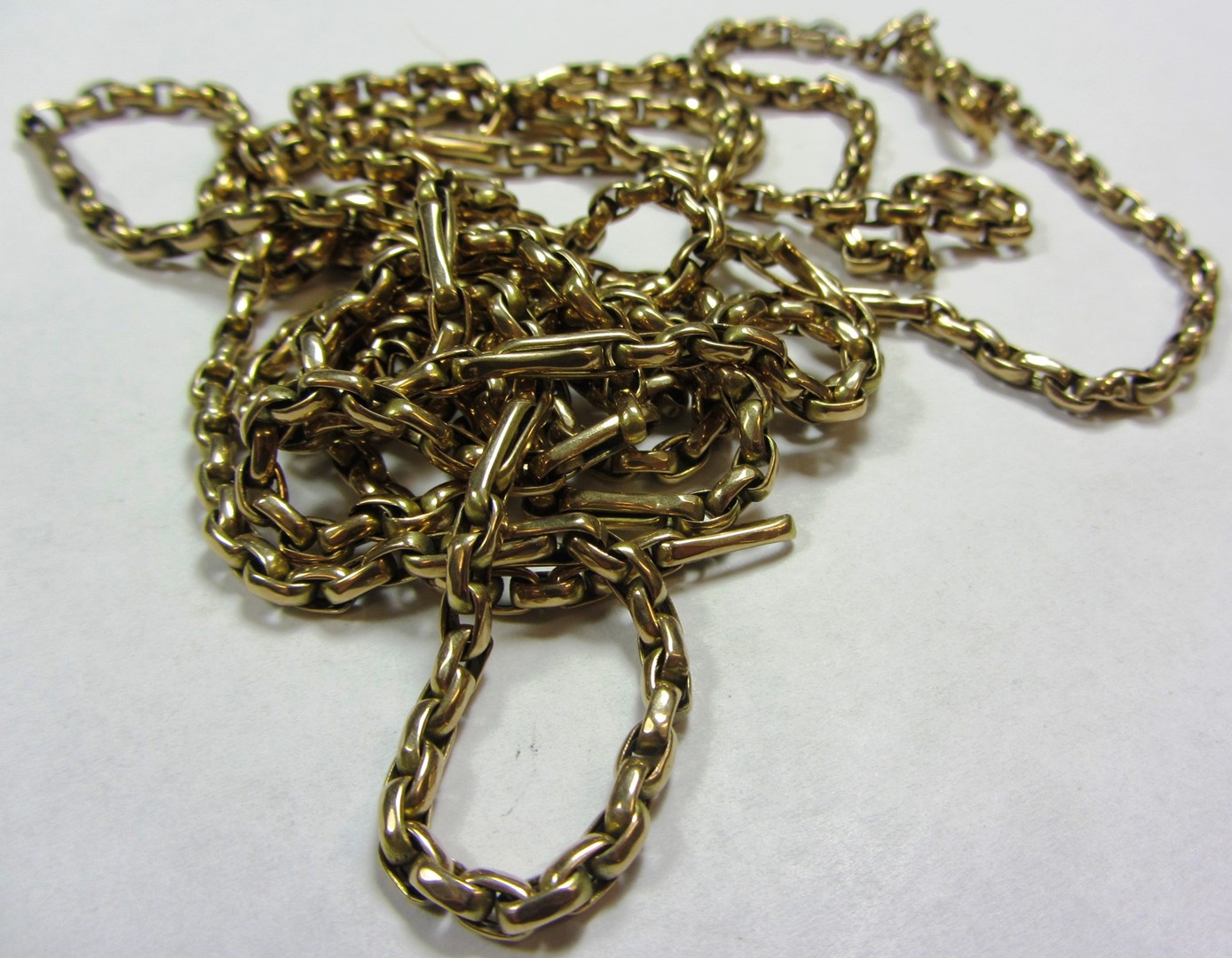 Appraisal: A gold long guard muff chain in an oval link