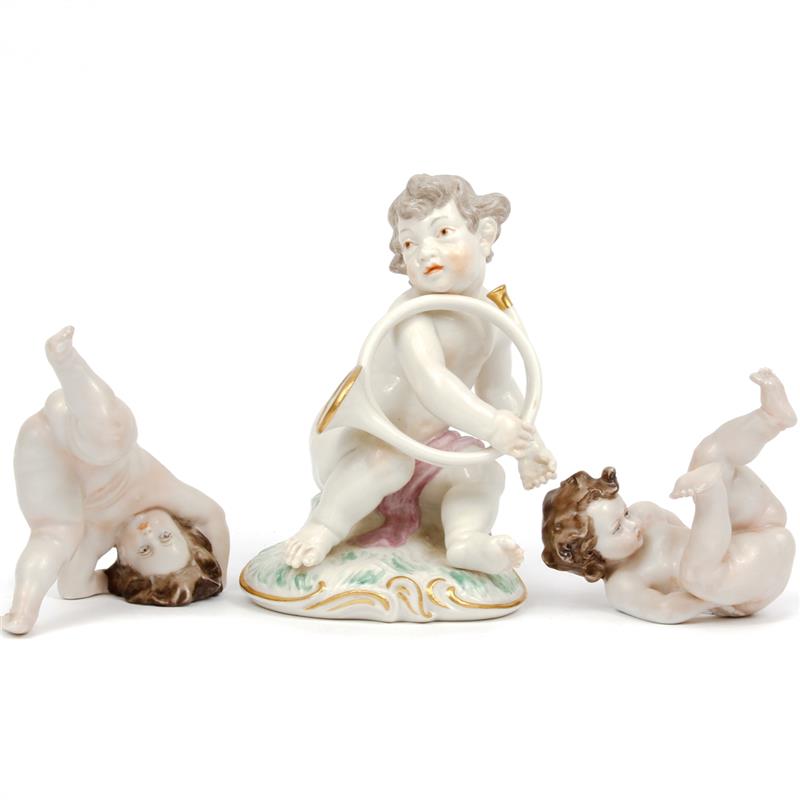 Appraisal: States Porcelain putti figures one with horn Marked on bottom