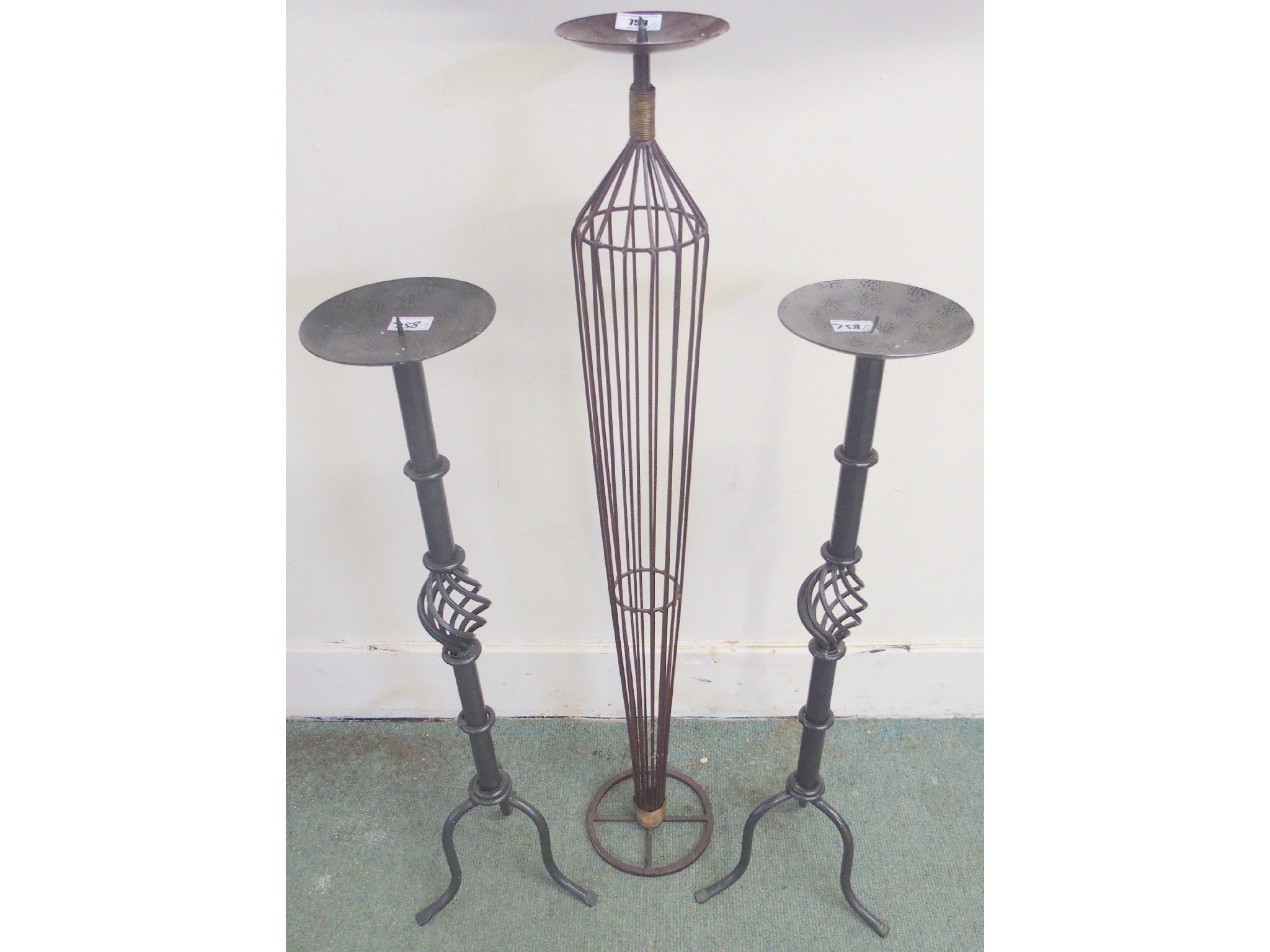 Appraisal: A pair of wrought iron candlesticks cm and a single