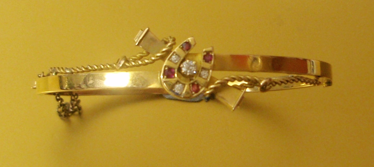 Appraisal: An Edwardian gold bangle set with diamonds and rubies to