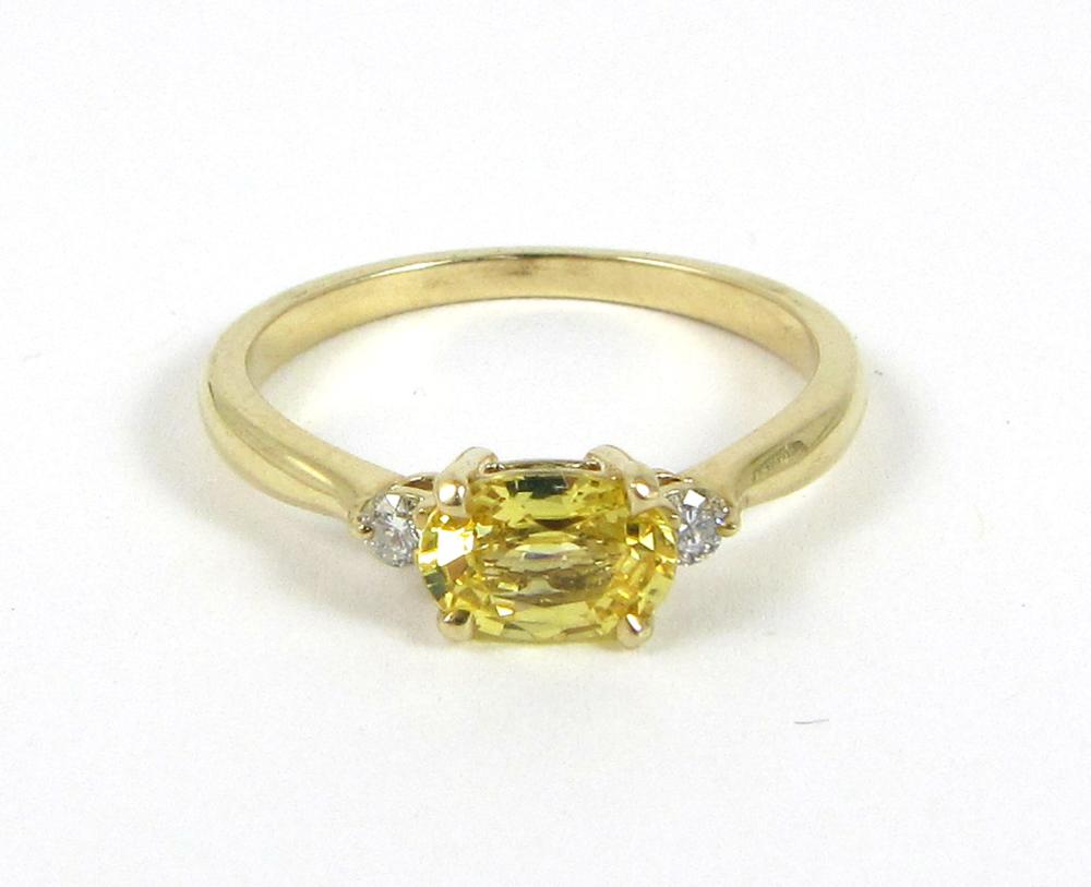 Appraisal: YELLOW SAPPHIRE DIAMOND AND FOURTEEN KARAT GOLD RING with two