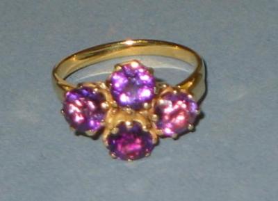 Appraisal: AN AMETHYST DRESS RING comprising four round-cut amethysts claw set