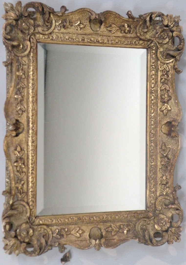 Appraisal: An Italian gilt wood and gesso wall mirror the shaped