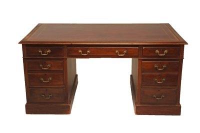 Appraisal: A mahogany pedestal desk fitted a surround of nine drawers