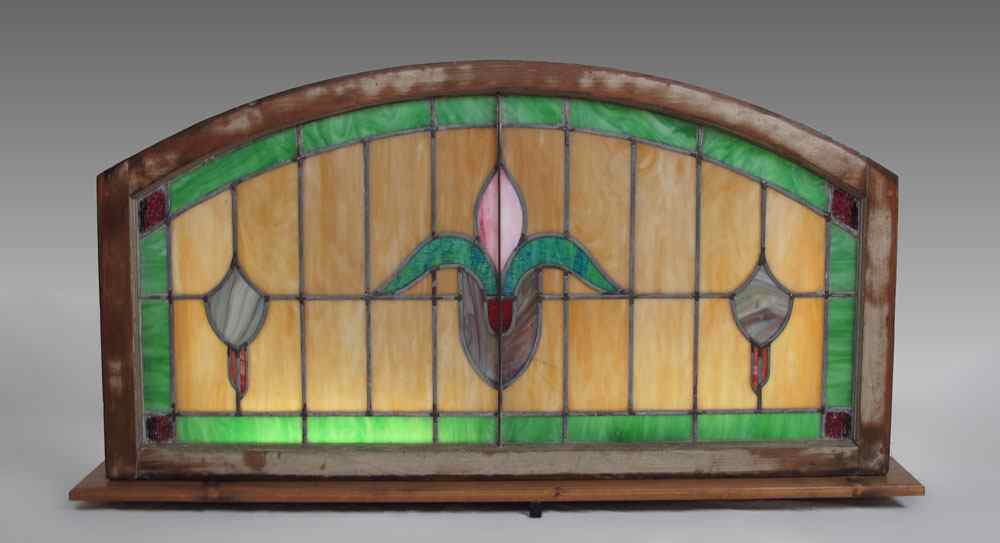 Appraisal: LEADED GLASS PANEL AND CUSTOM LIGHTED FRAME Flower and shield