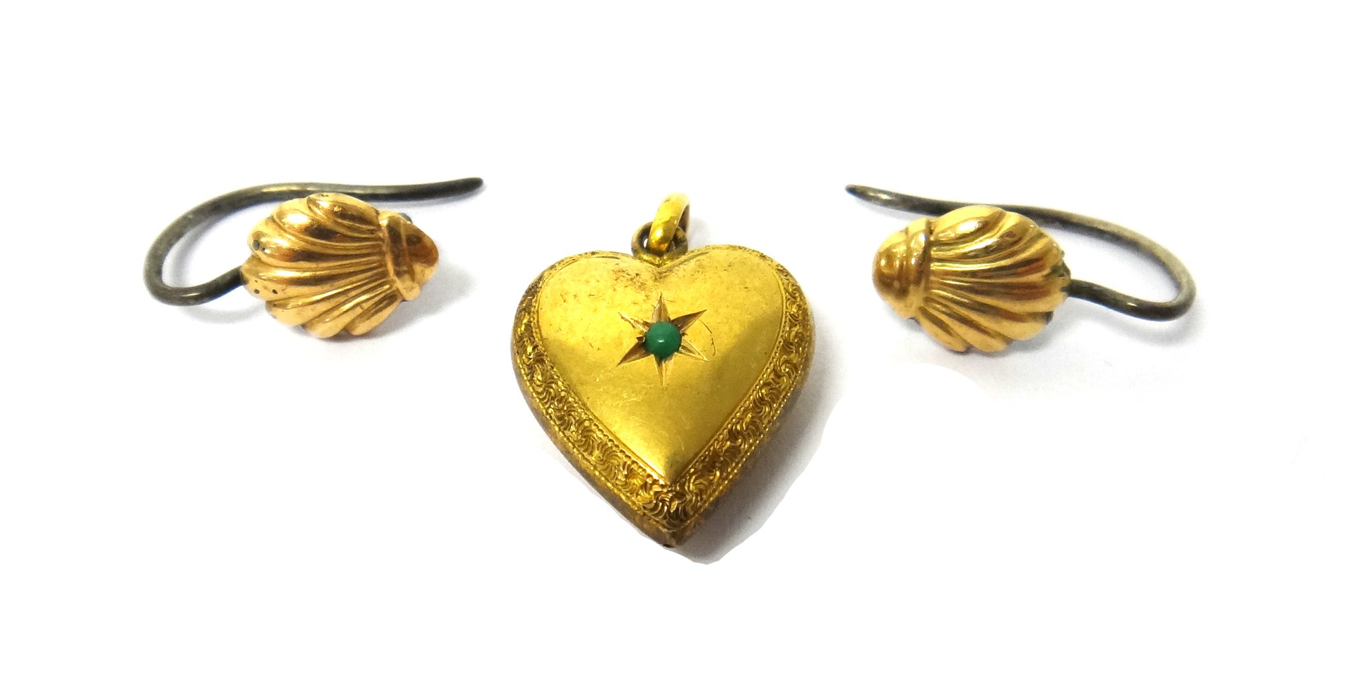 Appraisal: A turquoise set heart shaped pendant with engraved decoration and