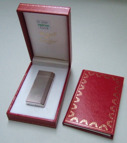 Appraisal: A Cartier Paris plated rectangular gas lighter with engine turned