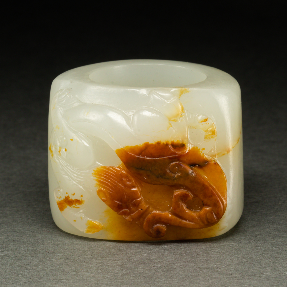 Appraisal: CHINESE WHITE AND RUSSET JADE ARCHER'S RING Chinese white and