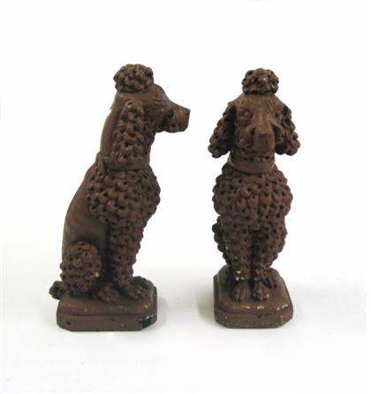 Appraisal: Pair brown painted of cast-stone poodlesOn rectangular base with canted