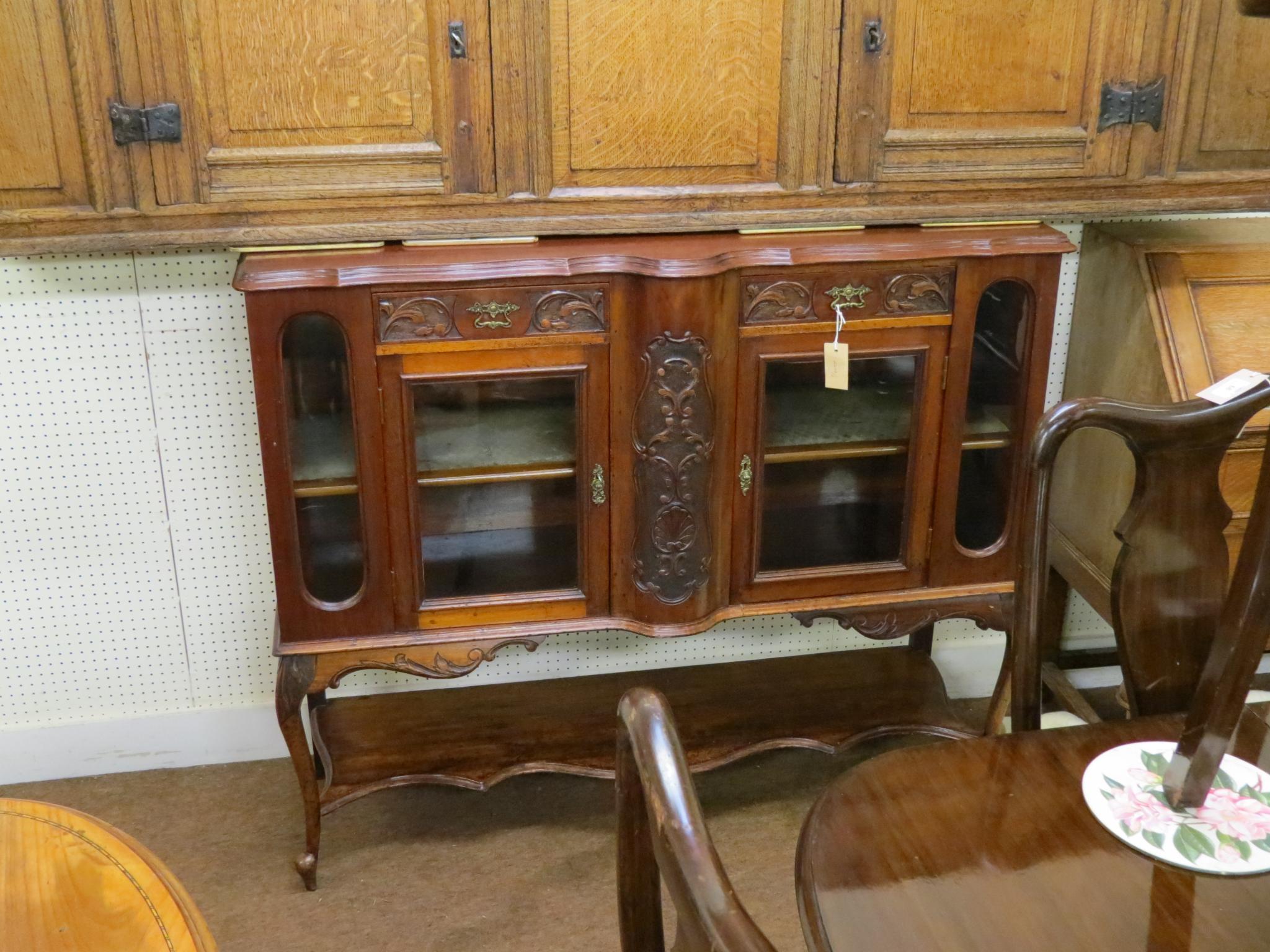 Appraisal: A late Victorian mahogany chiffonier two carved frieze drawers above