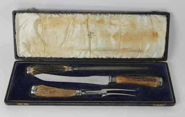 Appraisal: A three-piece plated carving set retailed by Walker Hall Sheffield