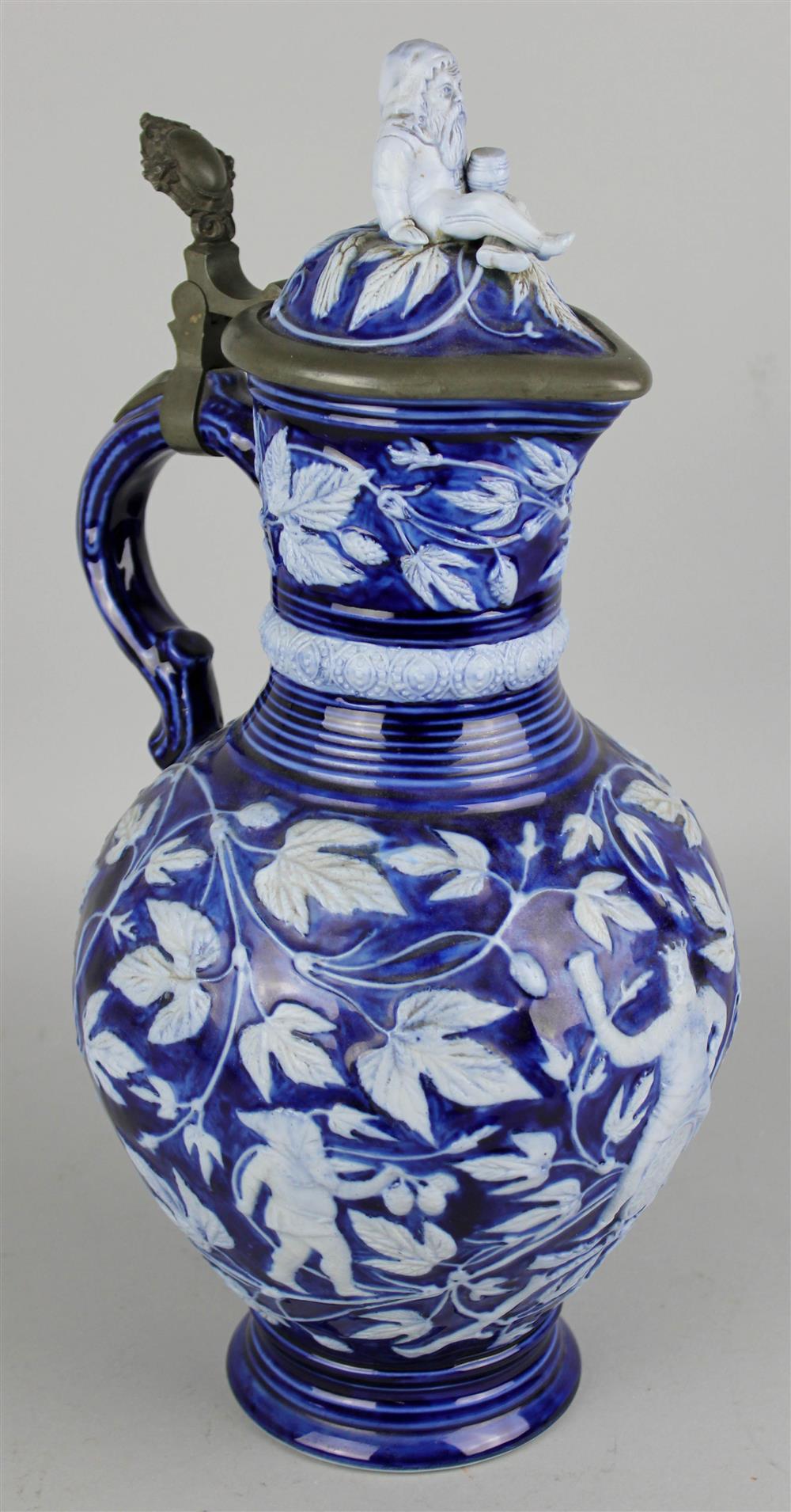 Appraisal: GERMAN PEWTER MOUNTED STONEWARE KING GAMBRINUS LIDDED EWER cobalt and