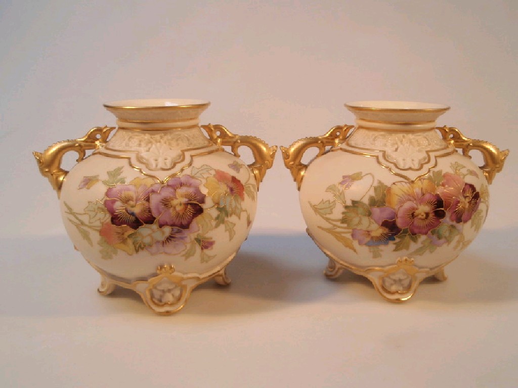 Appraisal: A pair of Royal Worcester model two handled vases decorated