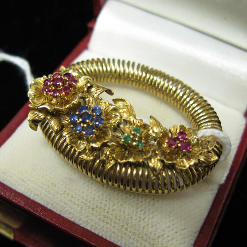 Appraisal: AN EIGHTEEN KARAT GOLD AND MULTI-COLOR GEMSTONE BASKET OF FLOWERS