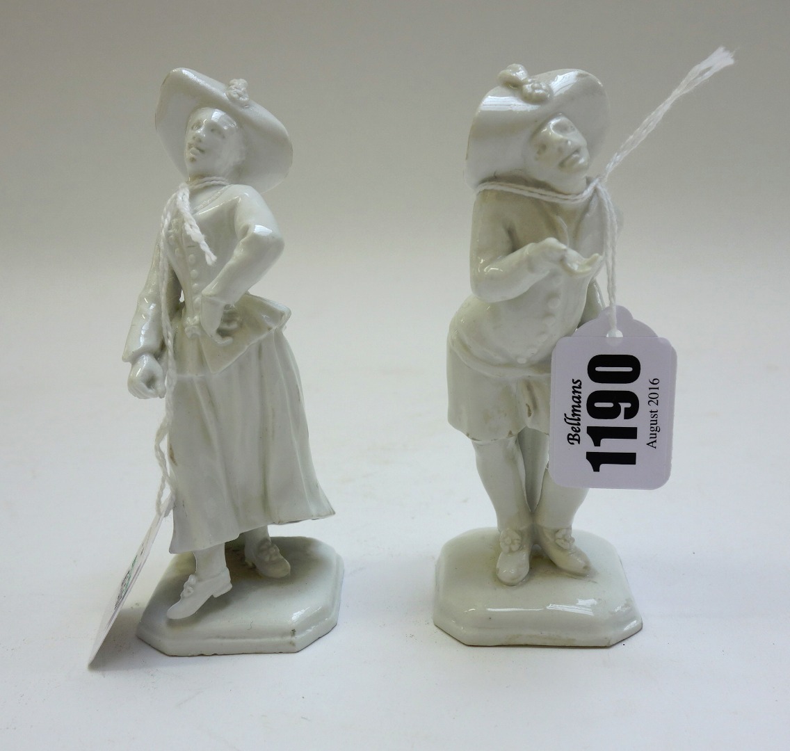 Appraisal: A pair of Vienna white glazed figures of begging Harlequin