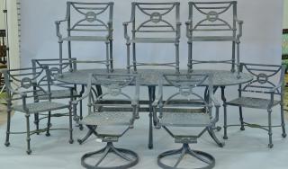 Appraisal: Heavy cast metal outdoor table and eight chairs basket weave