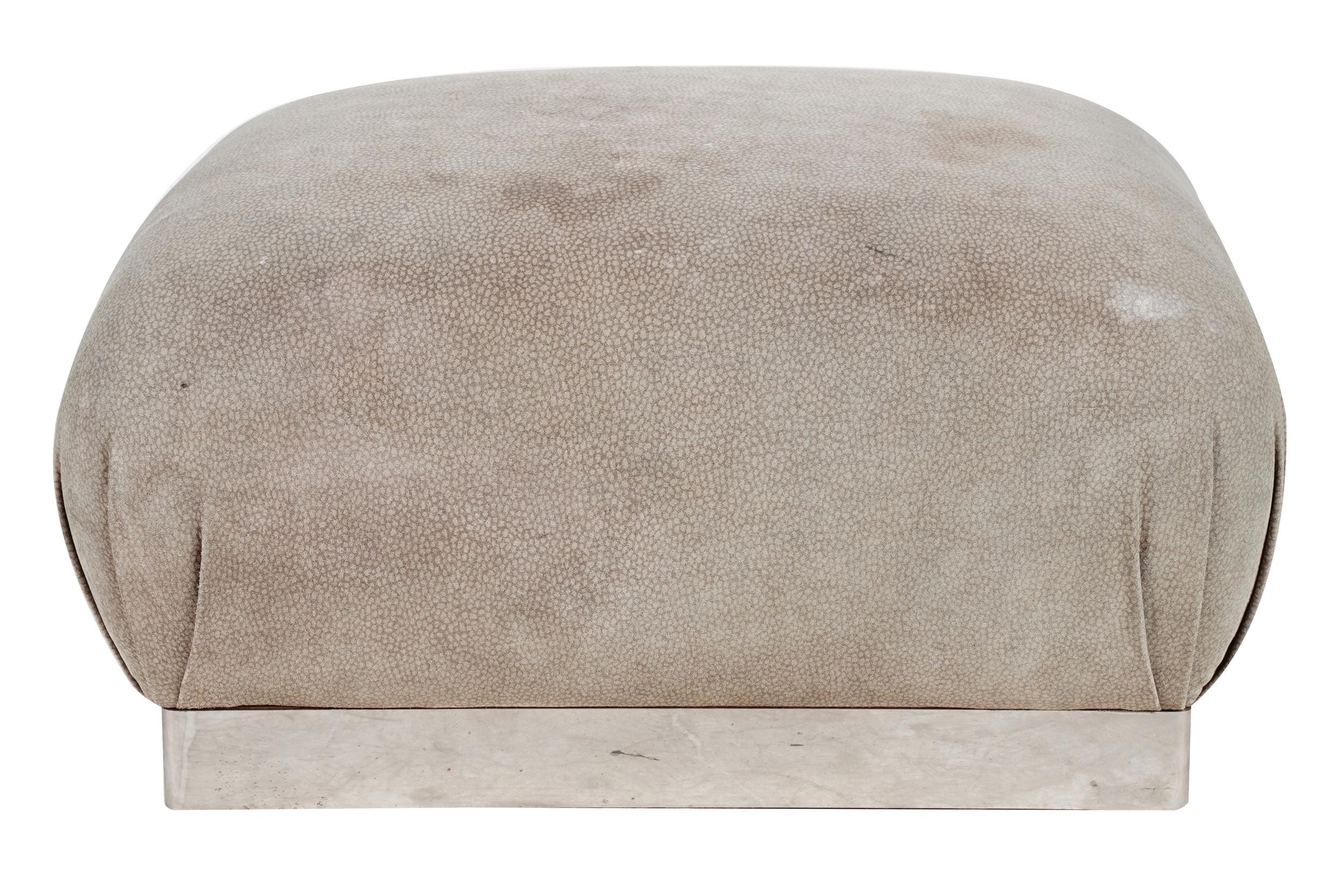 Appraisal: KARL SPRINGER STYLE UPHOLSTERED OTTOMAN unsigned the top with textured