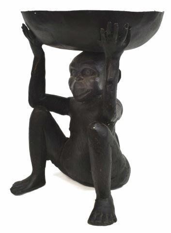 Appraisal: Patinated bronze seated monkey holding aloft a shallow bowl approx