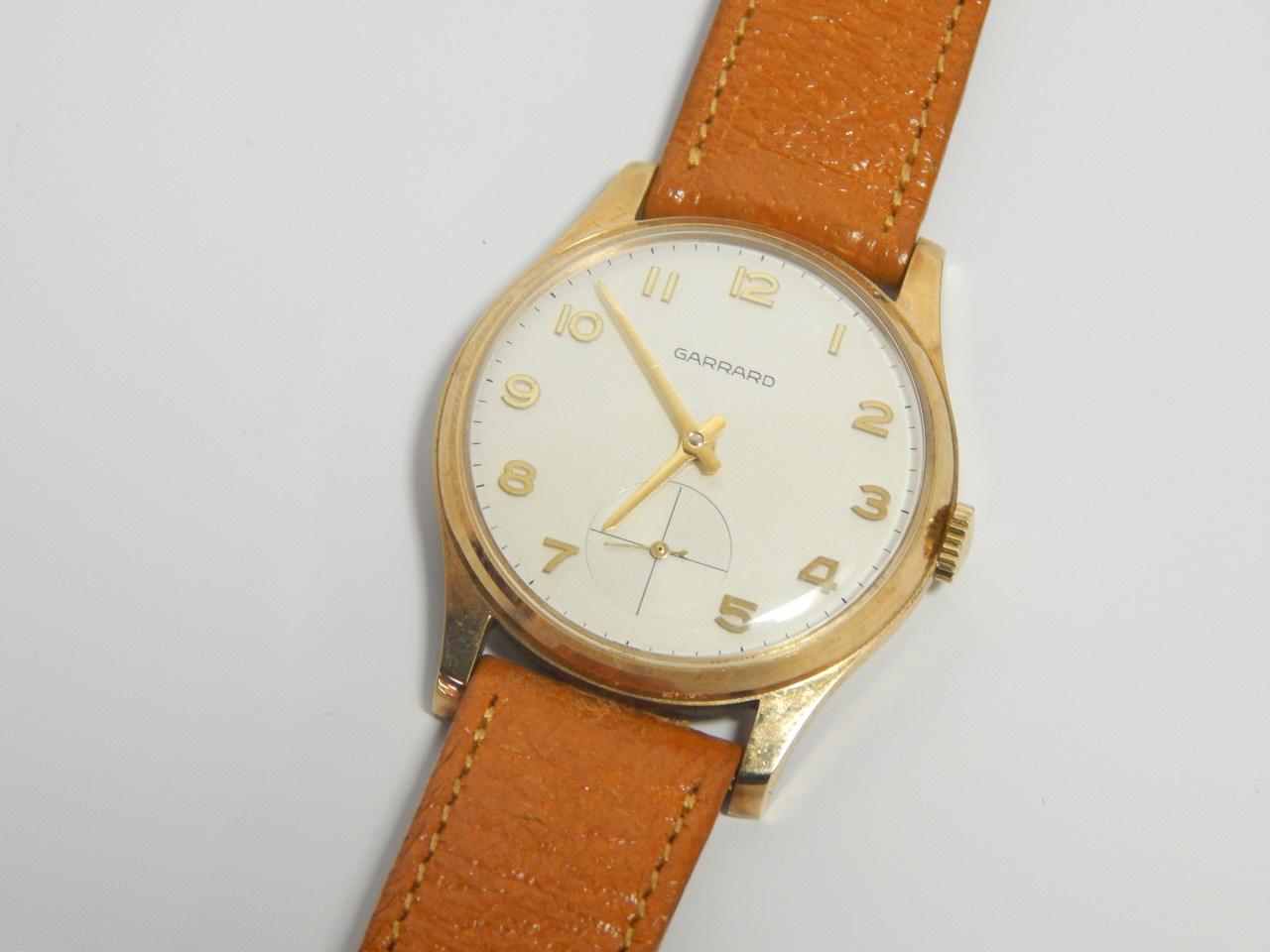 Appraisal: A Garrard gentleman's gold plated circular cased writstwatch white dial