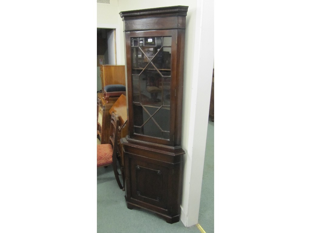 Appraisal: Edwardian mahogany glazed corner cabinet on stand