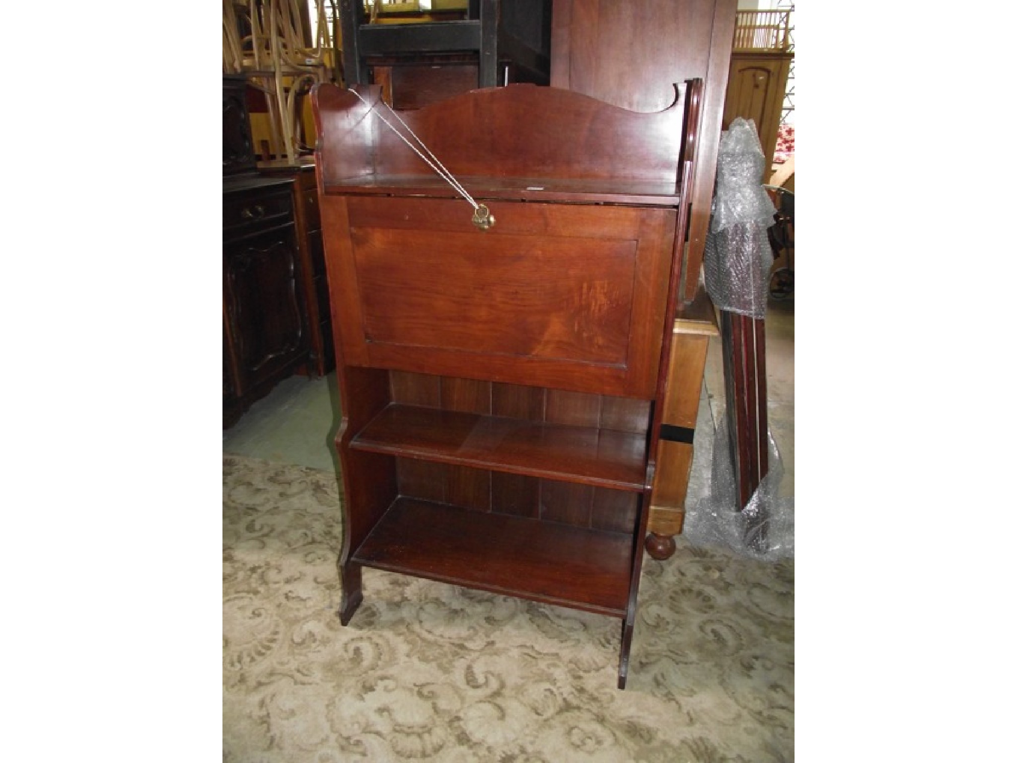 Appraisal: An Edwardian Art Nouveau style slim oak students type bureau