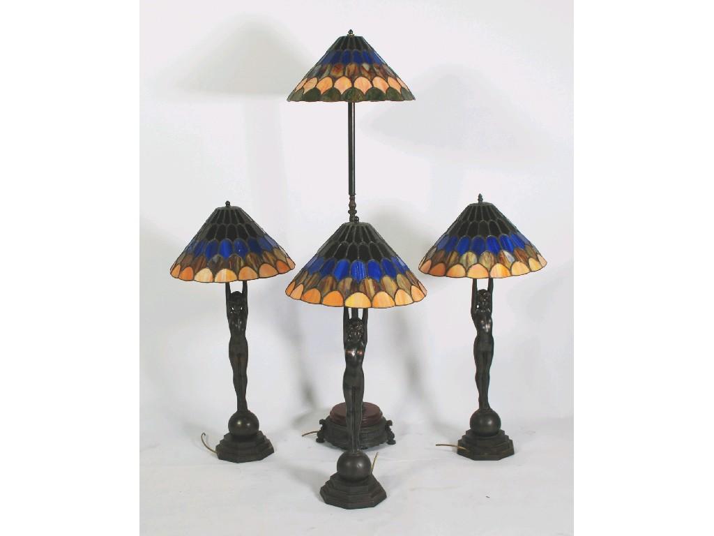 Appraisal: SET OF THREE TIFFANY STYLE PATINATED METAL FIGURAL TABLE LAMPS