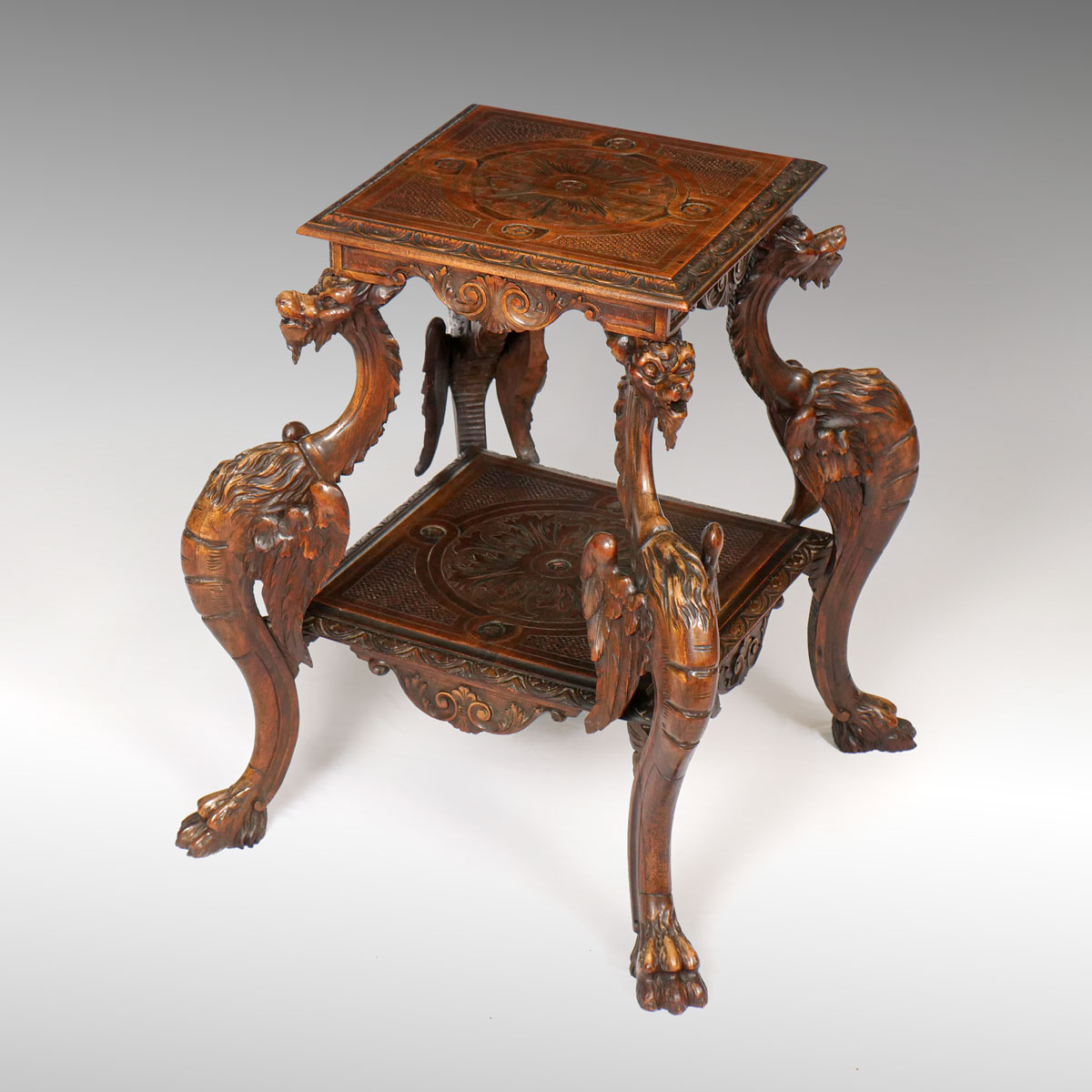 Appraisal: WALNUT RENAISSANCE REVIVAL CARVED GRIFFIN OCCASIONAL TABLE Having a low