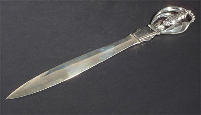 Appraisal: An Art Nouveau silver paper knife with flower terminal stamped