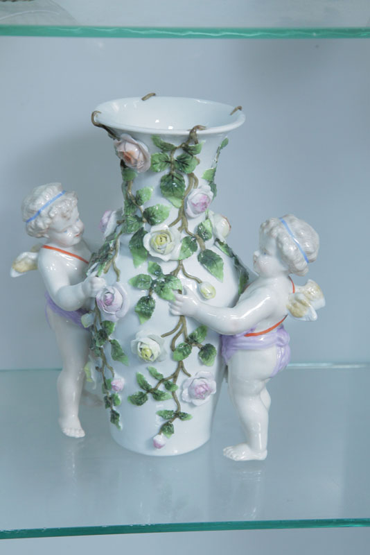 Appraisal: MEISSEN VASE White rose decorated vase flanked by two cherubs