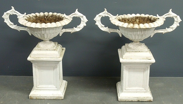 Appraisal: - Pair of cast iron planters on cast stone plinths