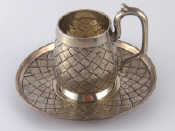 Appraisal: A Russian silver cup and saucer in trompe l'oeil basket