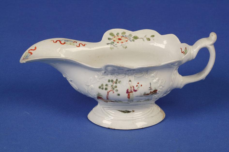 Appraisal: A FIRST PERIOD WORCESTER POLYCHROME SAUCEBOAT circa - modelled in