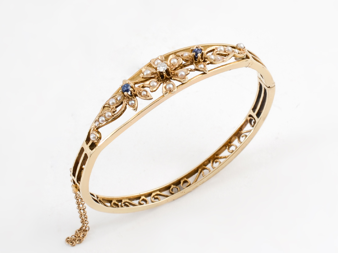 Appraisal: MID CENTURY BANGLE WITH DIAMONDS SAPPHIRES The Rococo style scroll