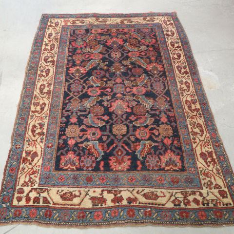 Appraisal: Semi-Antique Persian Handmade Rug stylized florals deep blue field '