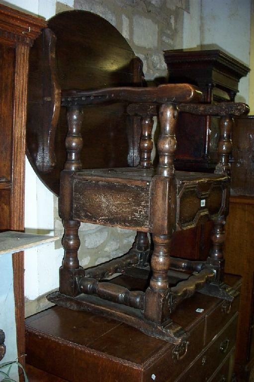 Appraisal: A Georgian oak monk seat with folding top the seat