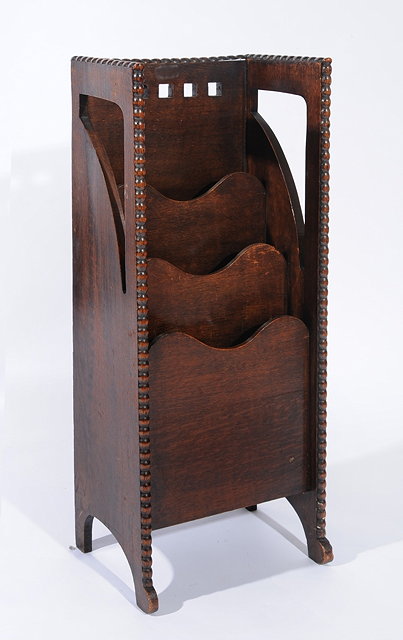 Appraisal: AN EARLY TH CENTURY OAK GLASGOW SCHOOL MAGAZINE RACK the