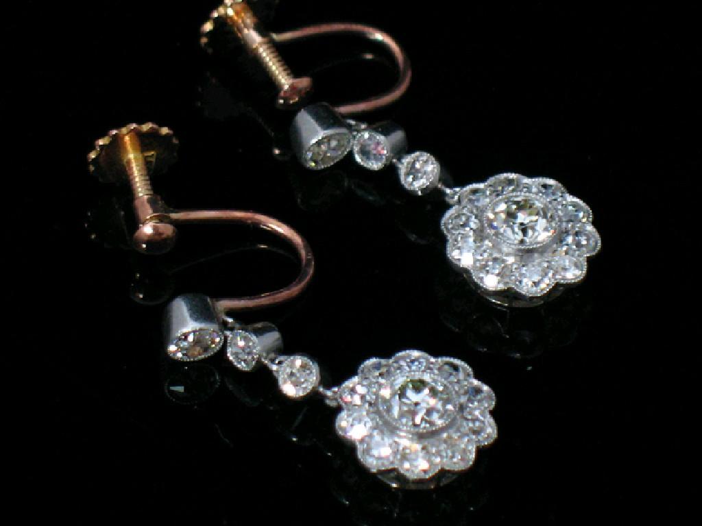 Appraisal: A PAIR OF DIAMOND CLUSTER DROP EARRINGS each drop set