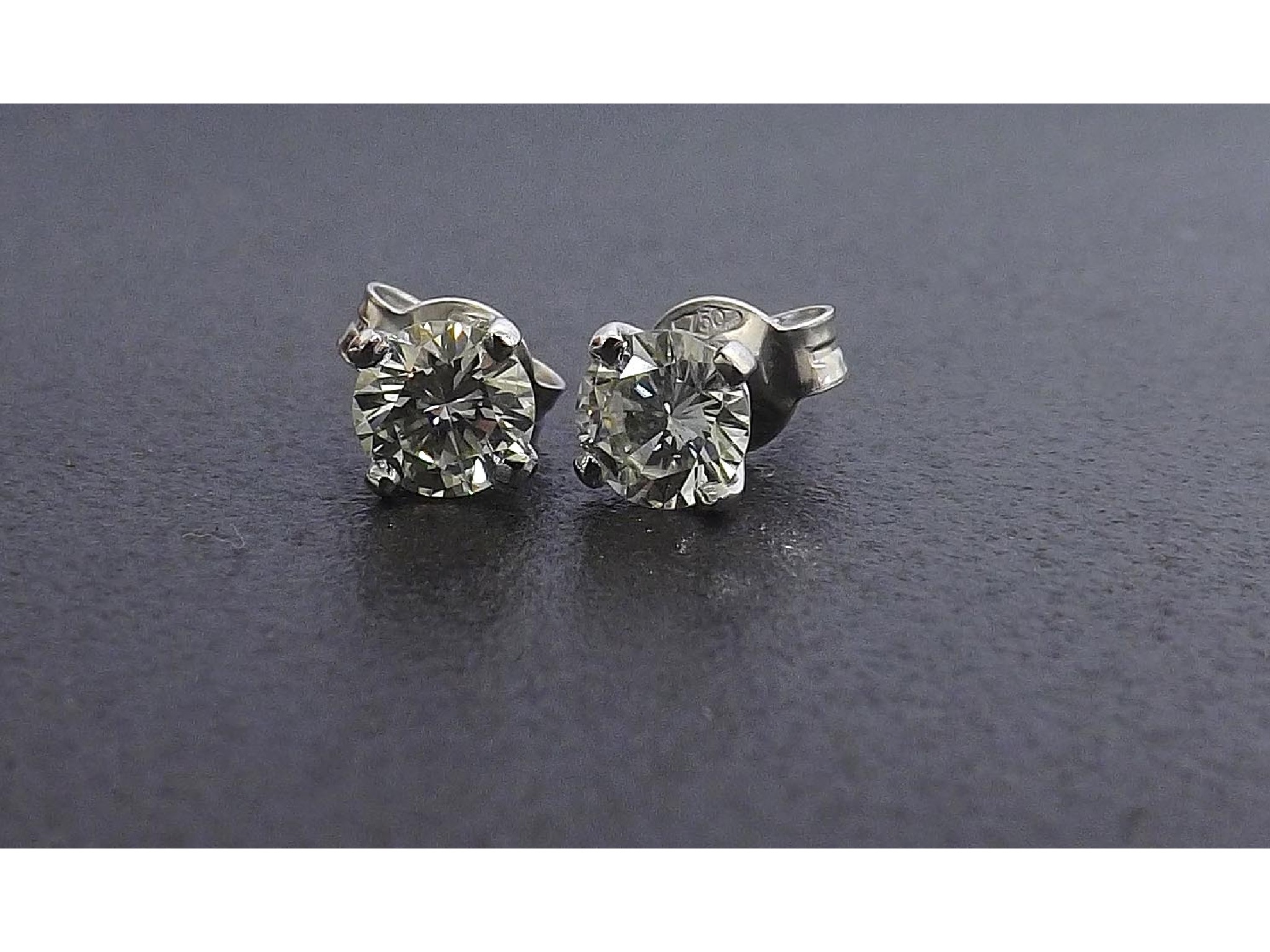 Appraisal: Good pair of round brilliant-cut diamond ear studs set in