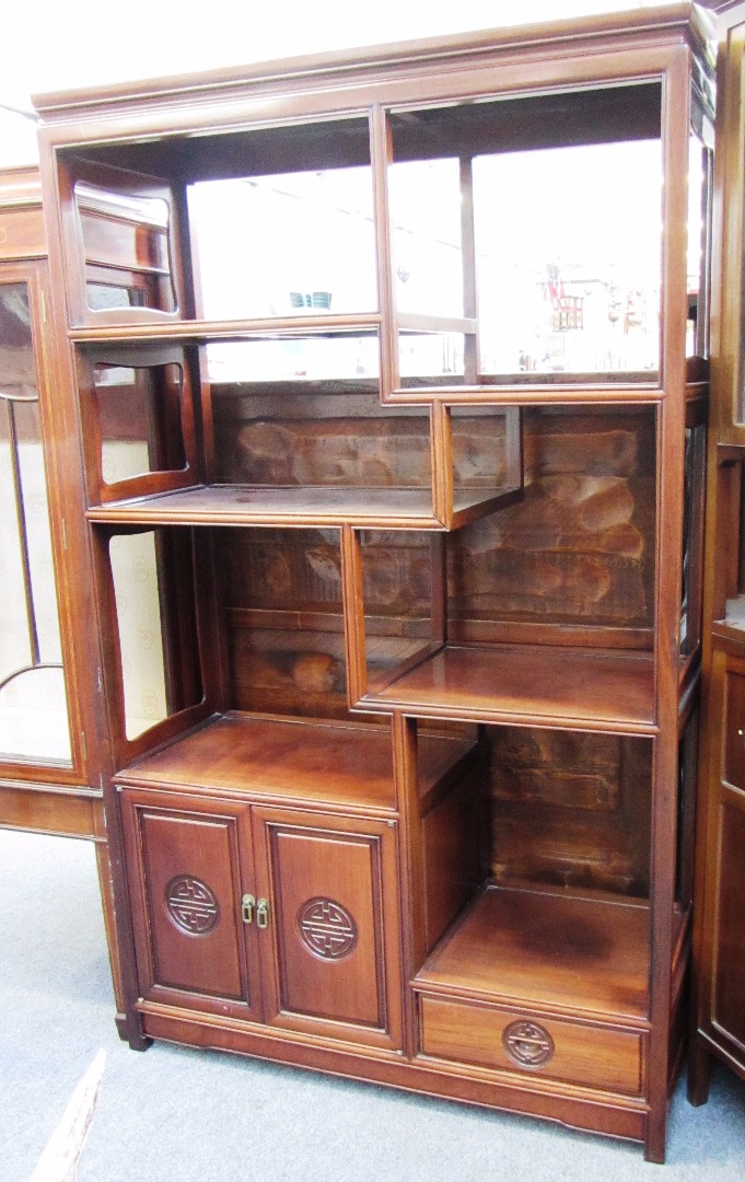 Appraisal: A th century Chinese hardwood double sided display stand cupboard