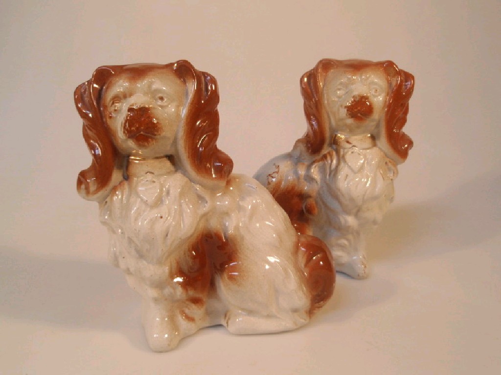 Appraisal: A pair of pottery comforter dogs in the form of