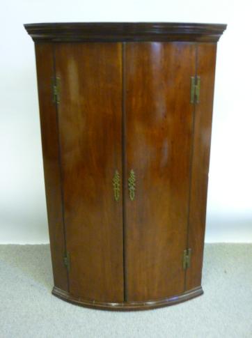 Appraisal: A GEORGE III MAHOGANY HANGING CORNER CUPBOARD c of bowed