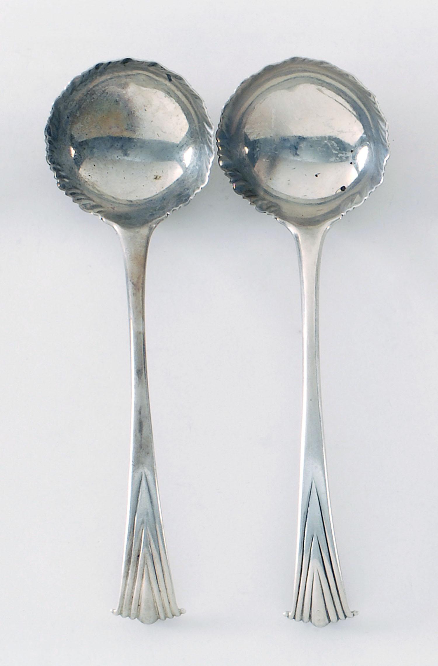 Appraisal: PAIR OF ENGLISH SILVER SAUCE LADLES London With nicely scrolled