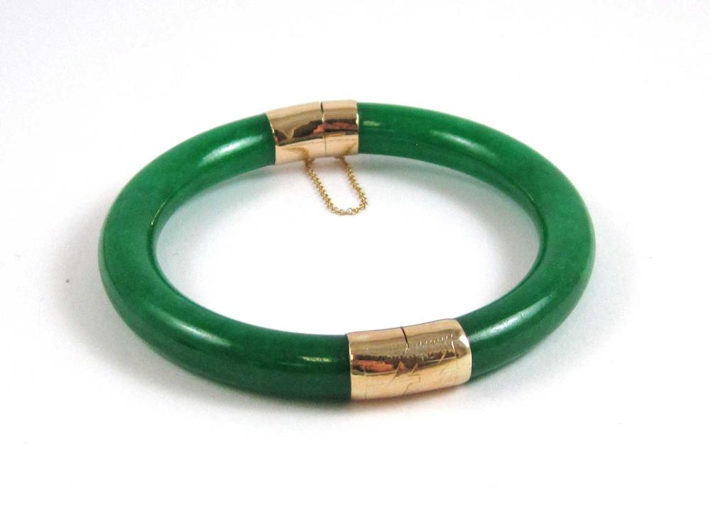 Appraisal: CHINESE JADE AND FOURTEEN KARAT GOLD BANGLE The round green