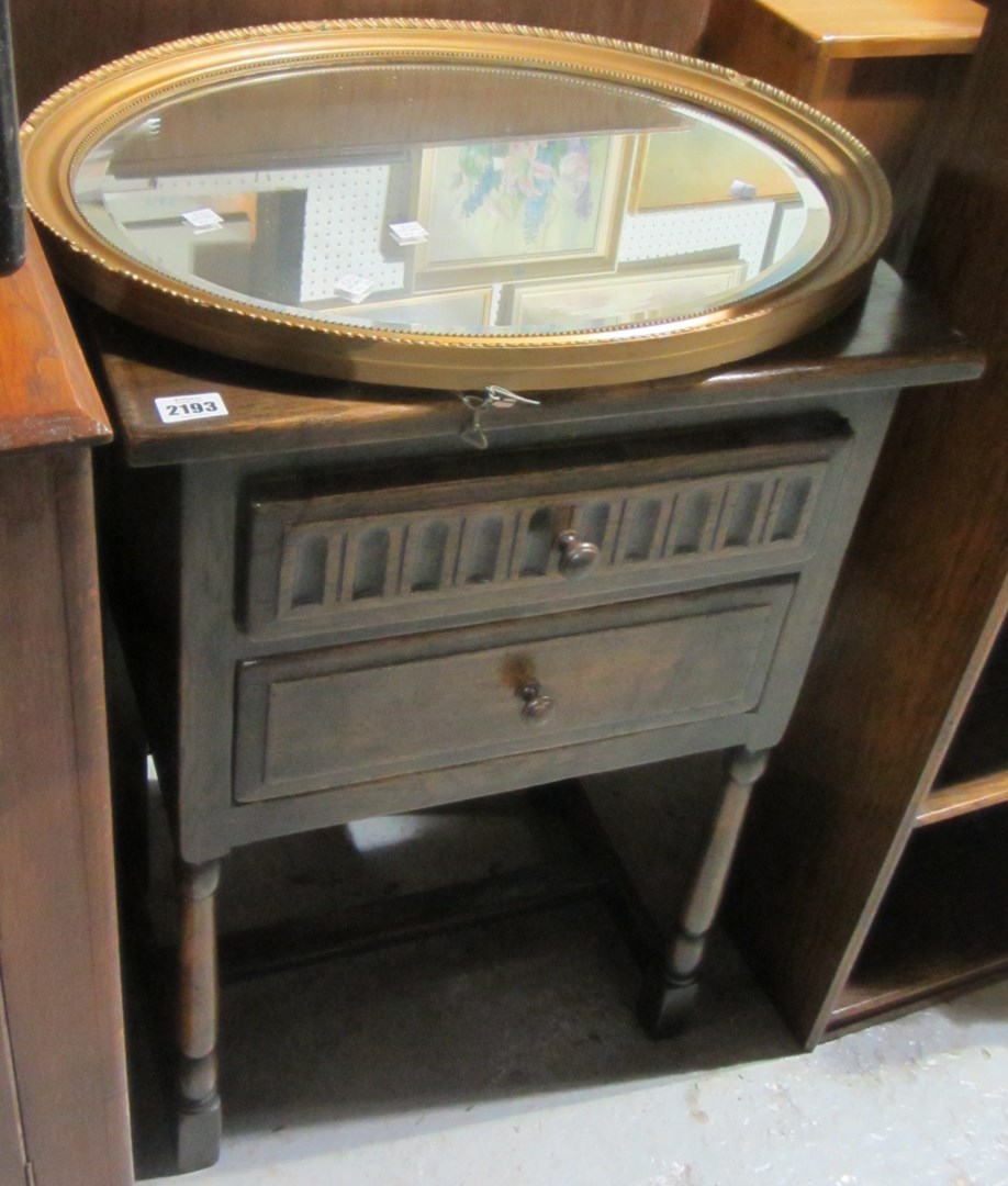 Appraisal: An oak two drawer side table and an oval gilt