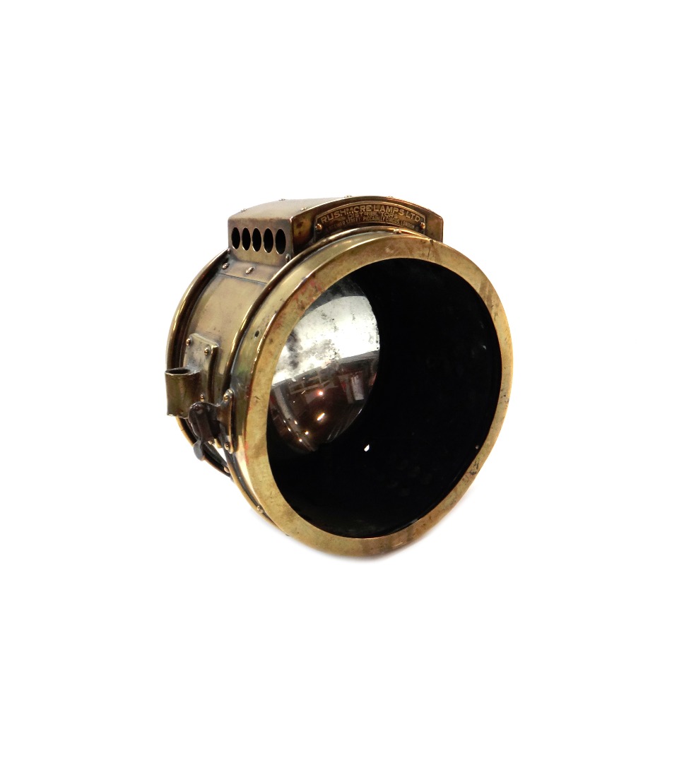 Appraisal: An eight inch brass cased 'Rushmore' automobile searchlight lacking front