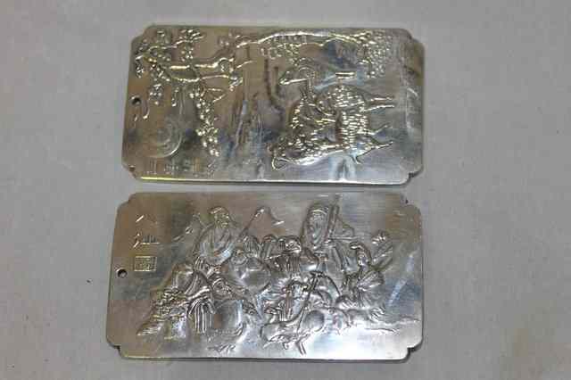 Appraisal: A PAIR OF CHINESE SILVER METAL PLAQUES one in the