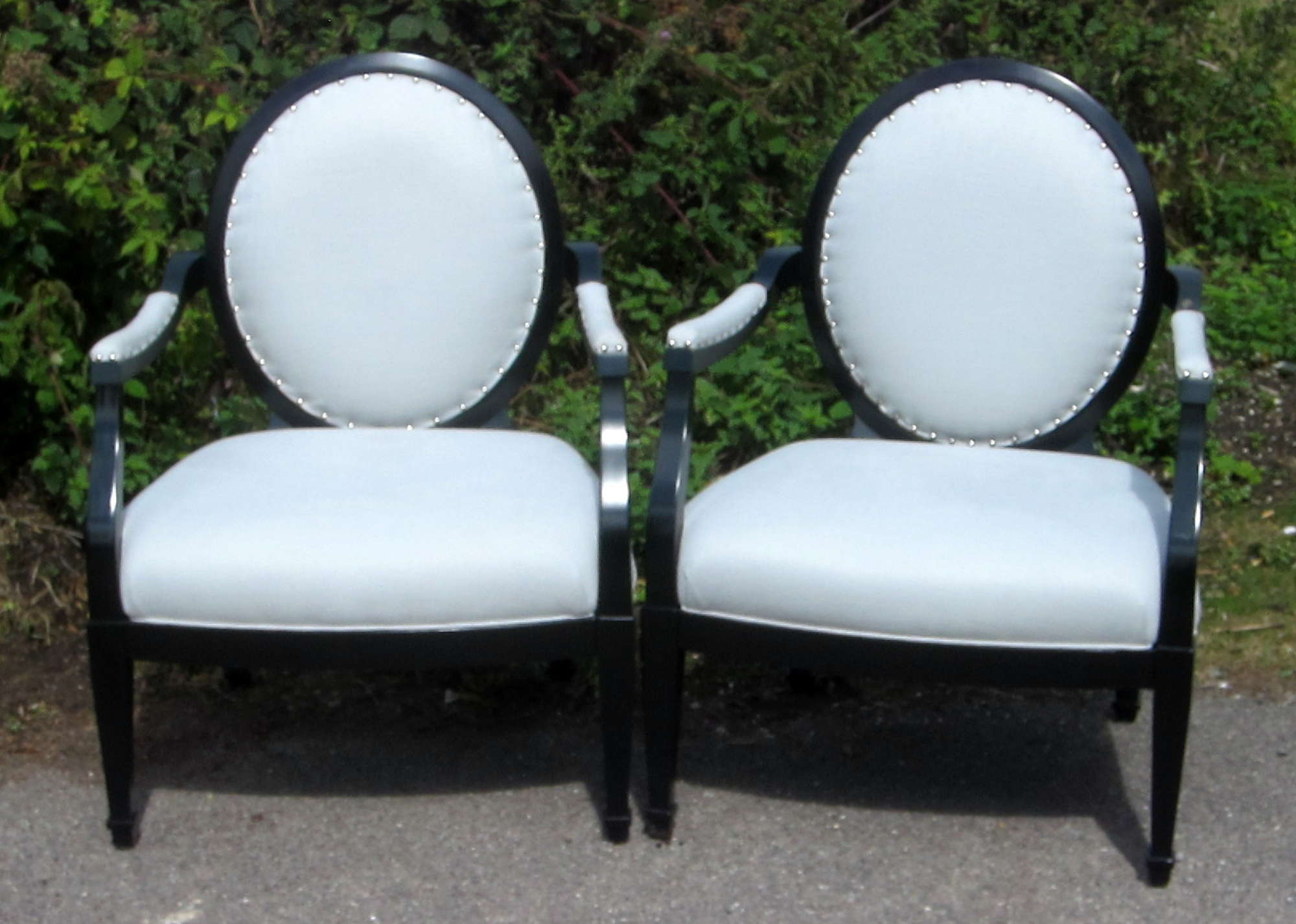 Appraisal: Pair of black painted and blue upholstered spoon back armchairs